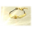 Schnatz bracelet with finely grained golden snip & braided leather straps